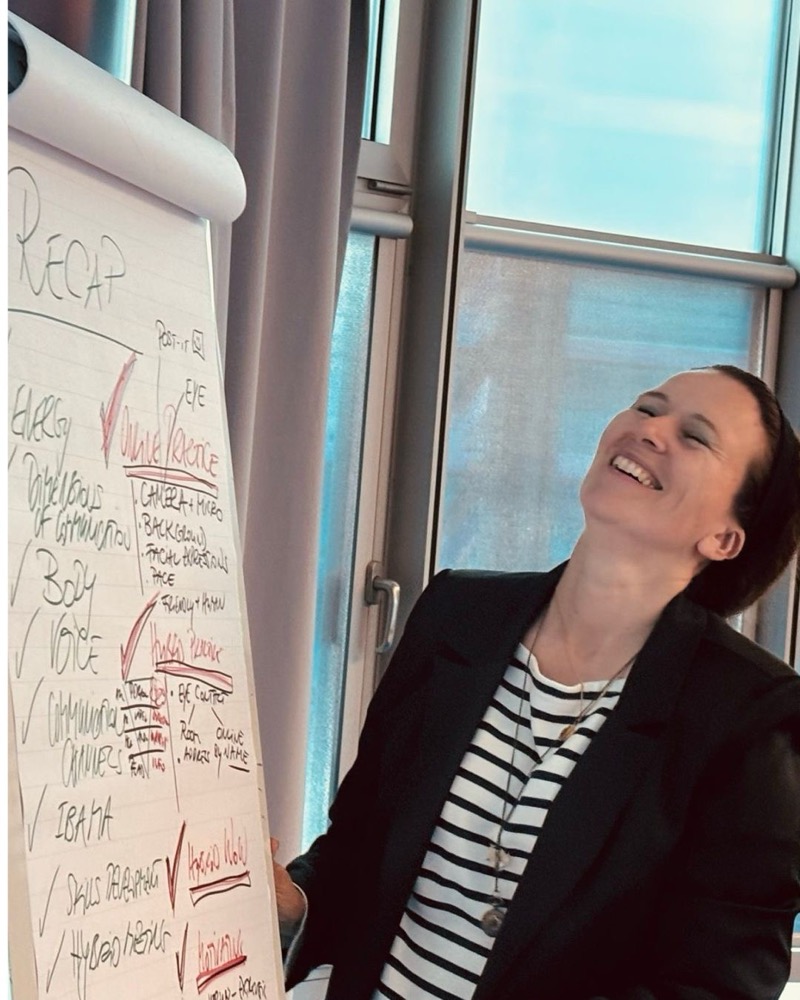 Trainer reviewing a session recap on a flipchart
